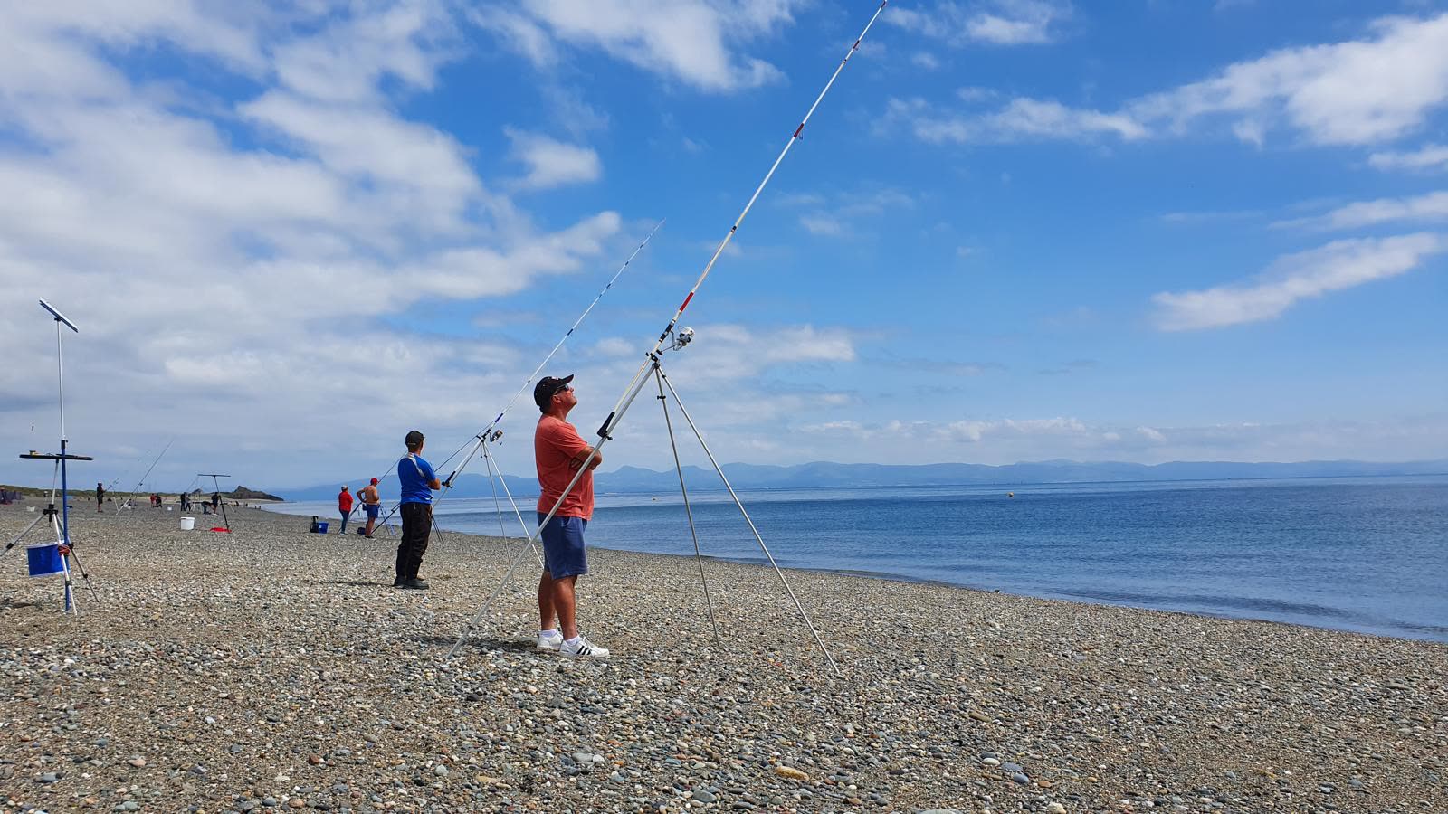 A line of anglers strung out along the beach