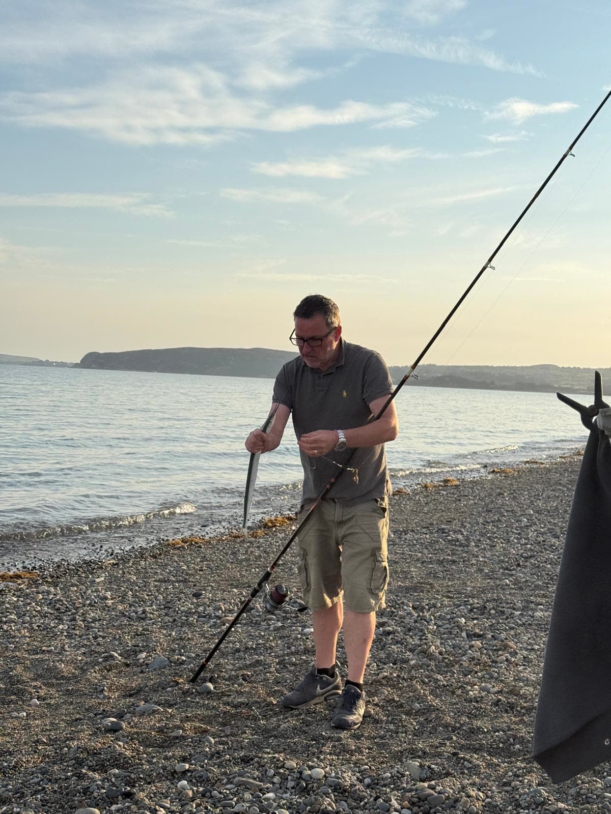 A fish from a shingle beach as the sun drops